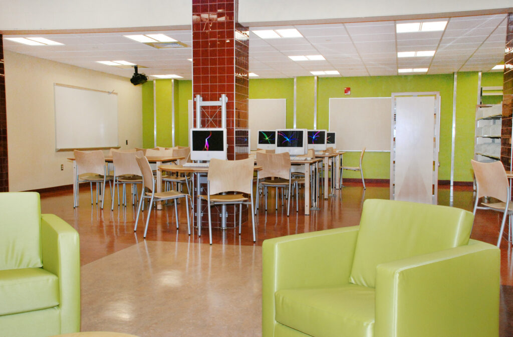 computer and media room with green wall and green soft seating